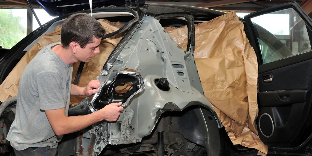 Technician repairing the rear quarter panel of a car